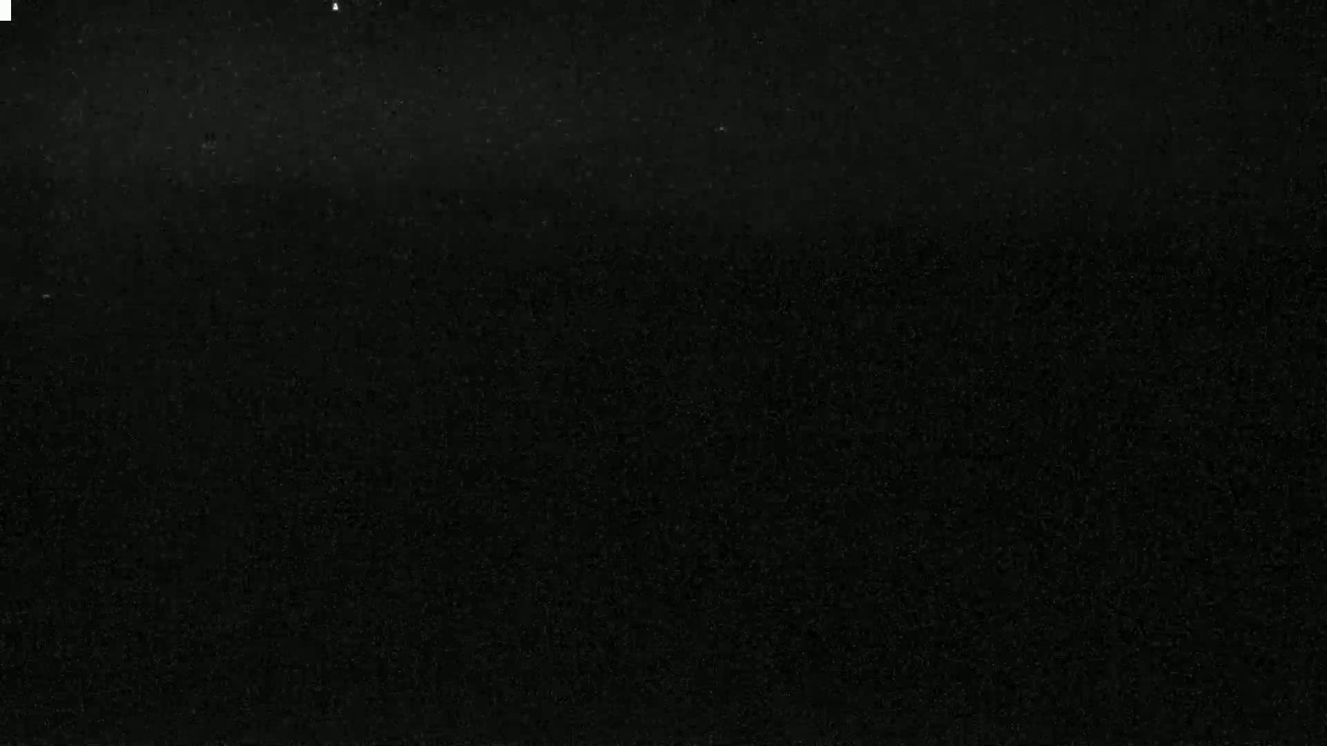 The image shows a uniformly dark, possibly nighttime, scene with a slightly grainy texture.