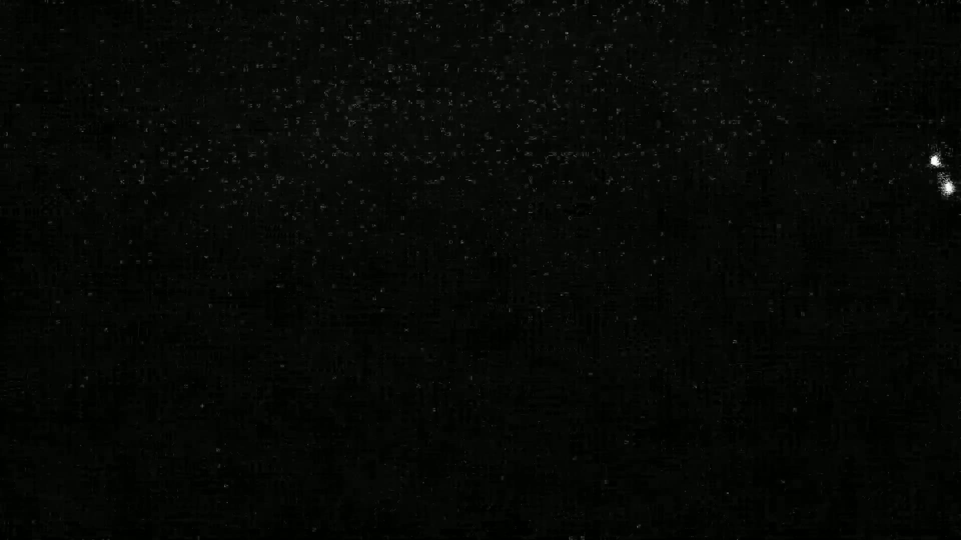 A mostly black image shows a scattering of very small, faint white specks.