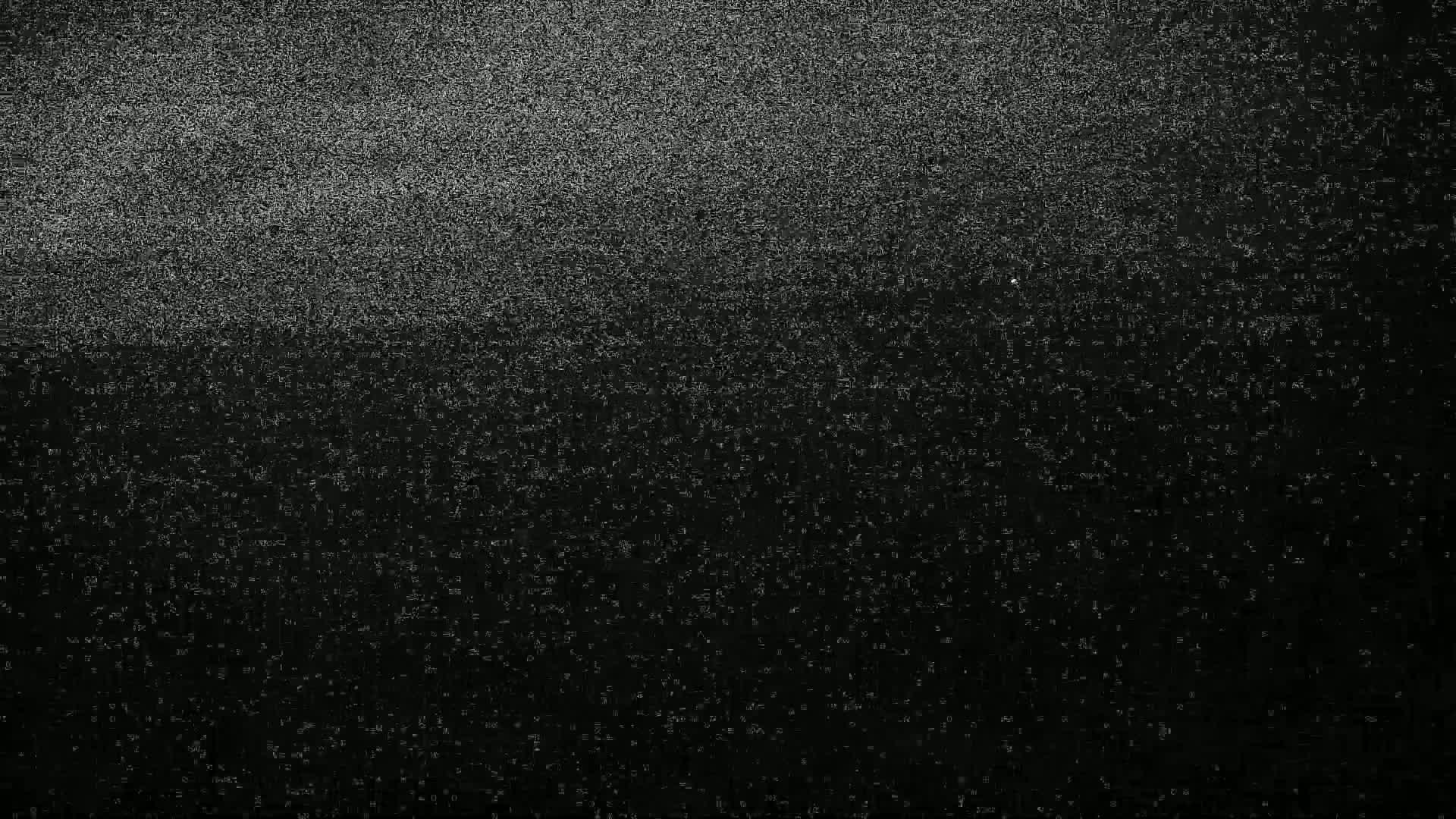The image shows a dark screen filled with static, with a brighter concentration of static at the top.
