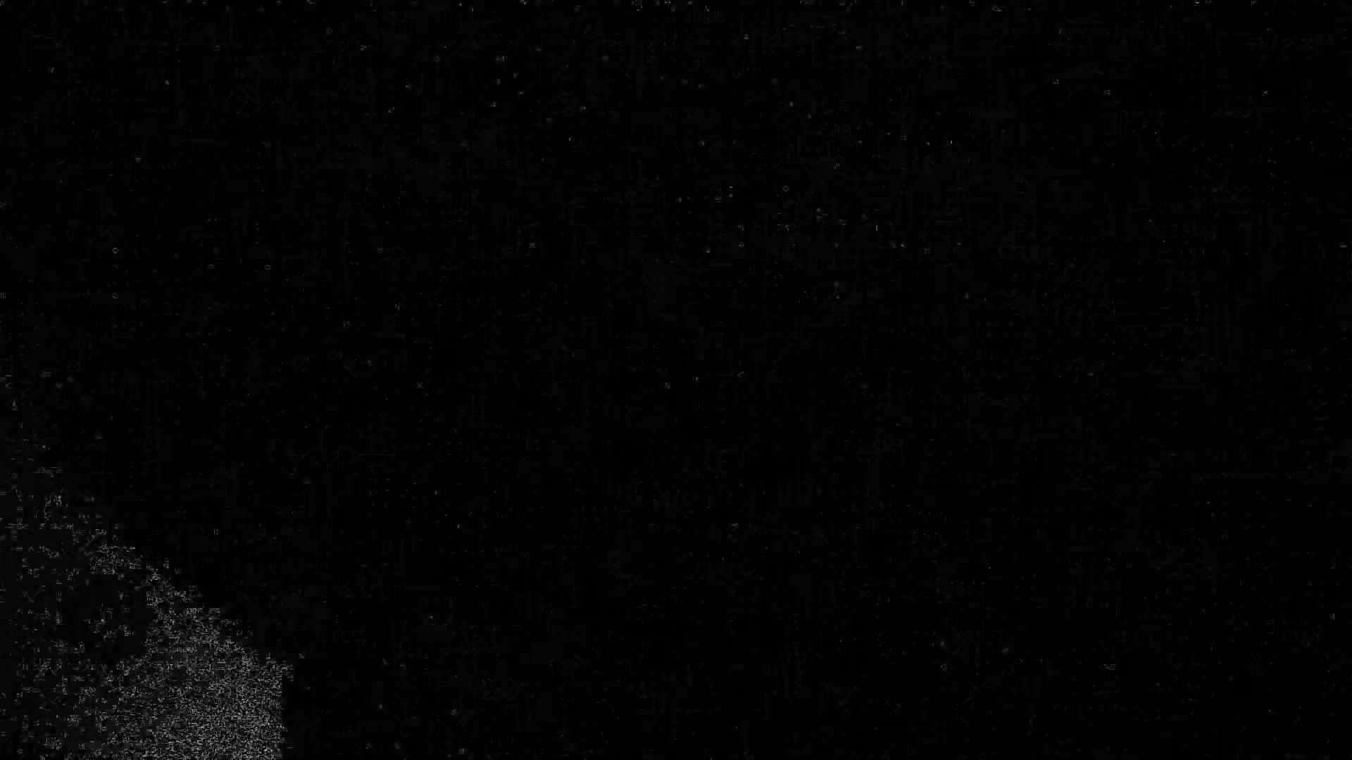 A mostly black image with a small, slightly brighter, grainy area in the bottom left corner.