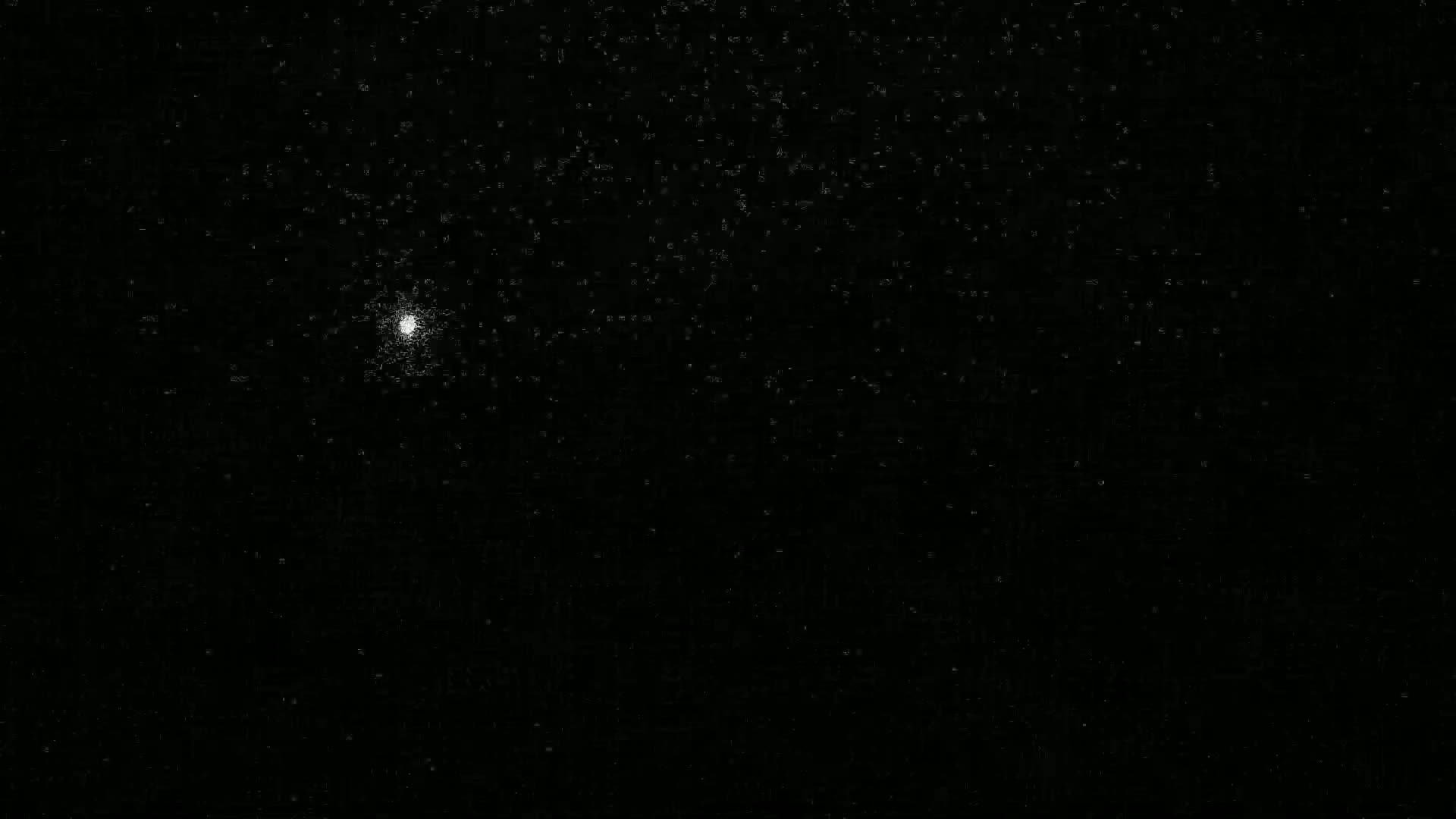 A bright, slightly blurry point of light is visible against a dark, speckled night sky.