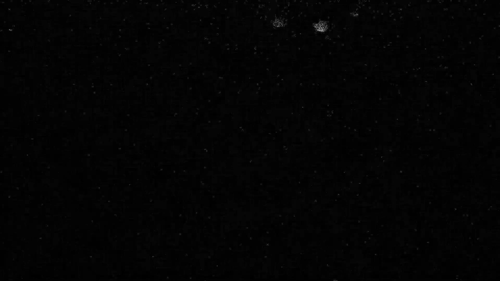 The image displays a dark, nearly black field mottled with numerous small white and gray specks, and a few larger, brighter, amorphous dust-like spots concentrated in the upper center.