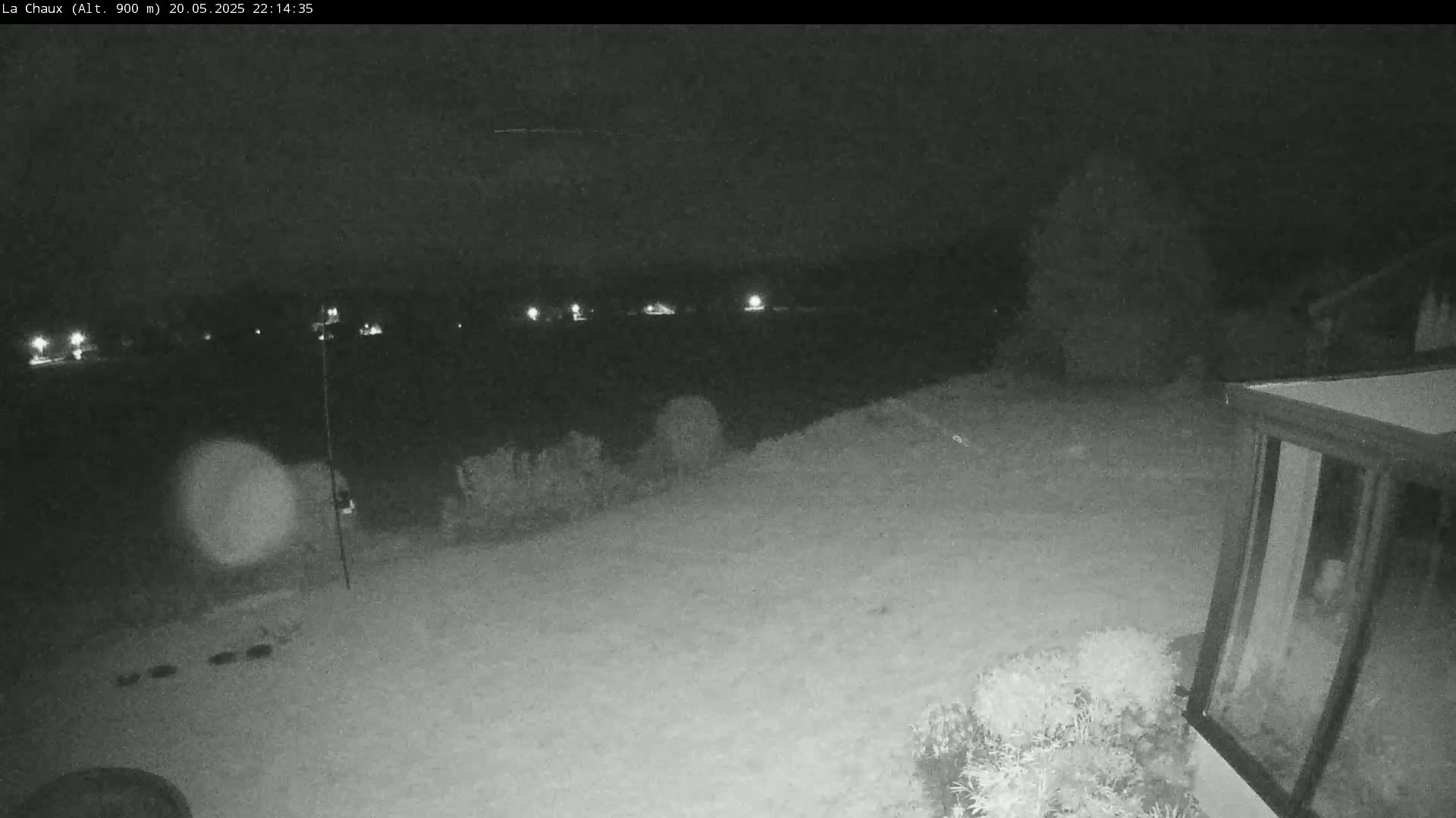 A nighttime, snow-covered backyard scene is visible, with a house and distant lights.