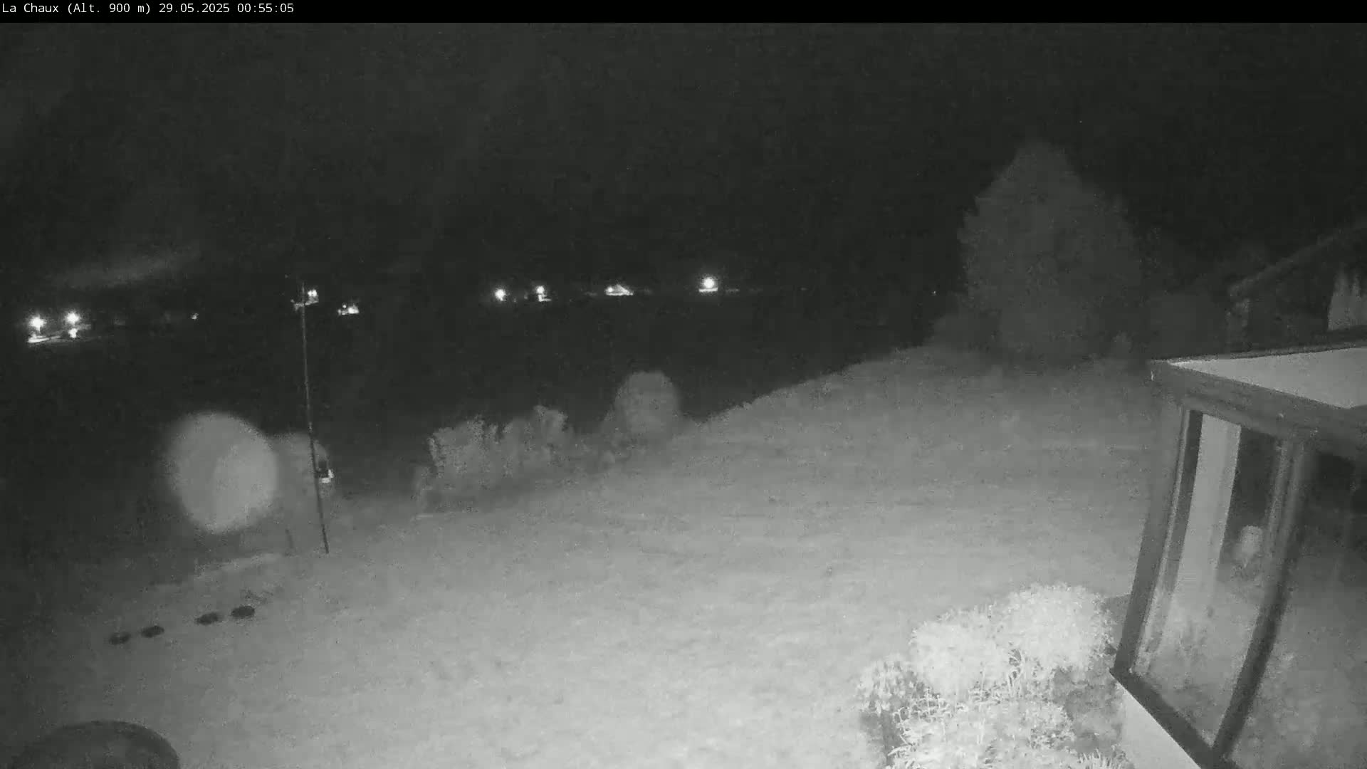 A snow-covered backyard is visible at night, illuminated by distant lights and a partially visible structure with a glass door.