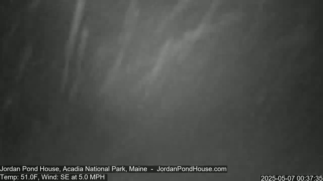 A dark, foggy scene with faint streaks of lighter gray suggesting movement in the air.
