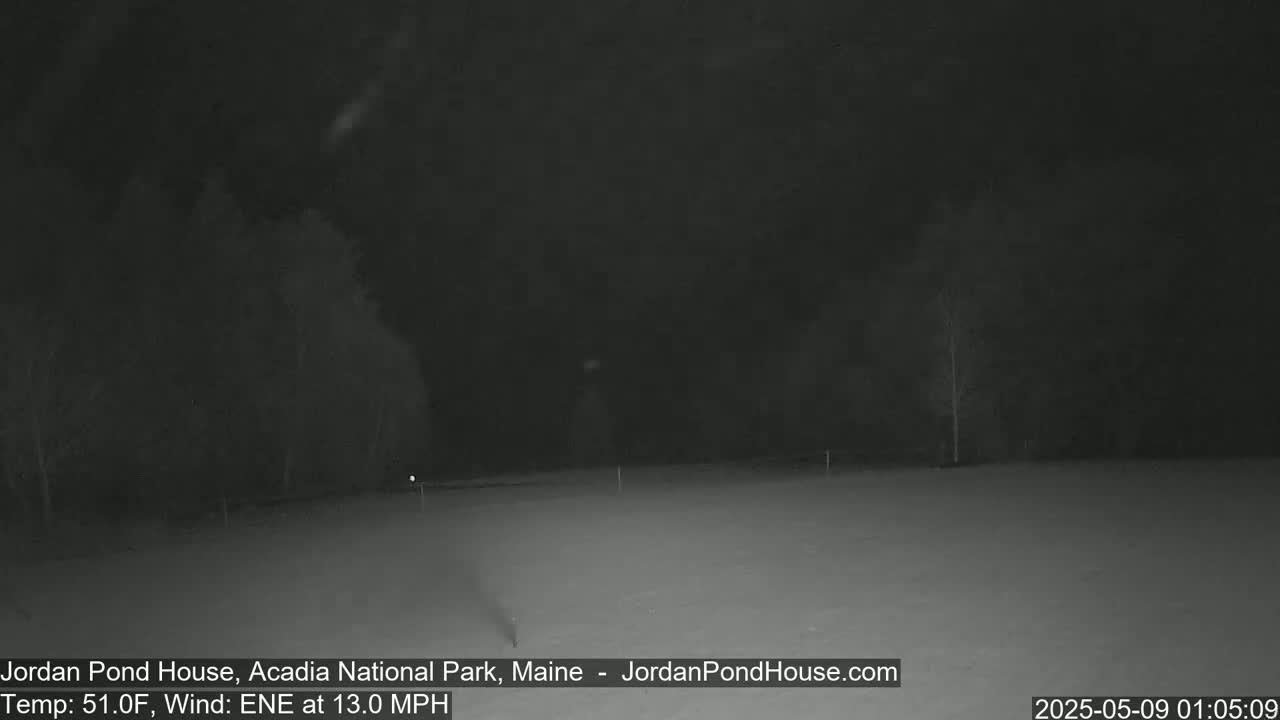 A snow-covered field is visible at night under a dark sky with a 13 mph east-northeast wind and a temperature of 51°F.