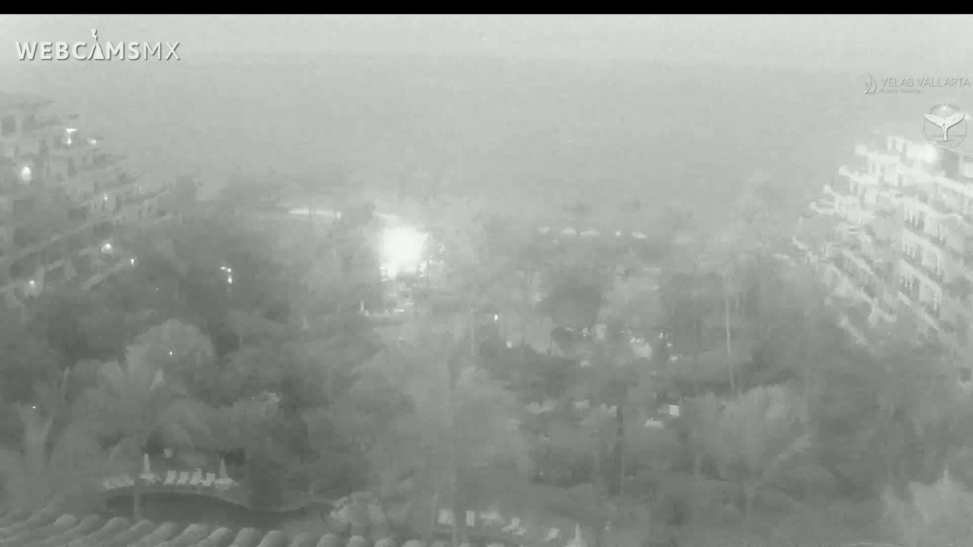 A hazy, nighttime view shows resort buildings surrounded by trees and landscaping.