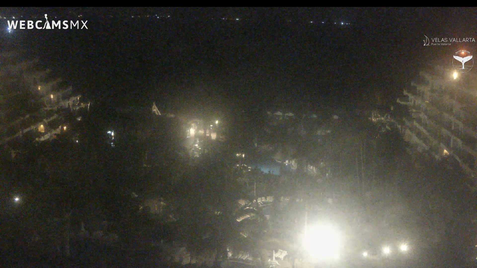 A nighttime, aerial view of a resort complex with dimly lit buildings and landscaping.
