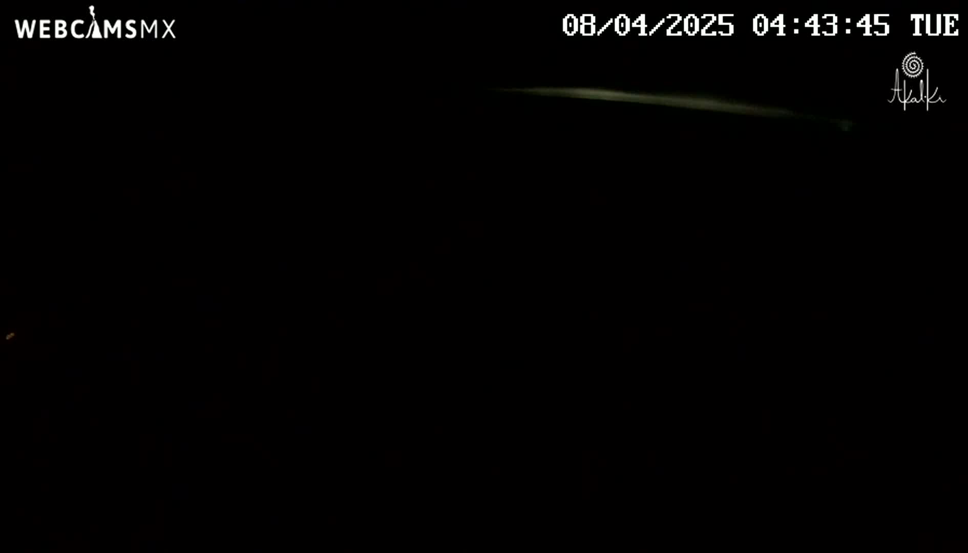 A faint, bright line appears across a mostly dark, nighttime sky.
