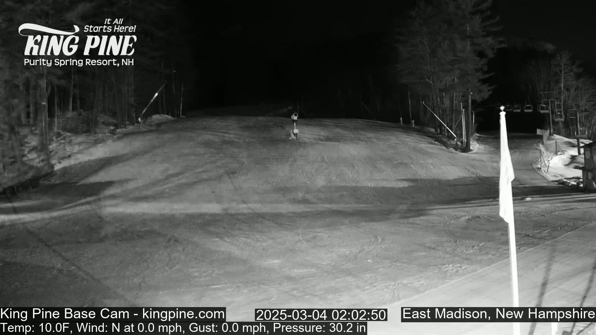 A nighttime, snow-covered ski slope is visible, with calm winds and a temperature of 10°F.