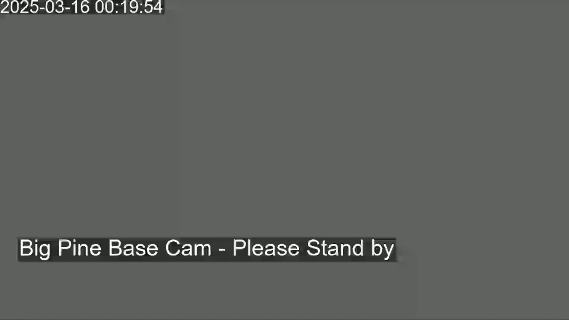 The image is a solid dark gray screen with the message "Big Pine Base Cam - Please Stand by" at the bottom.