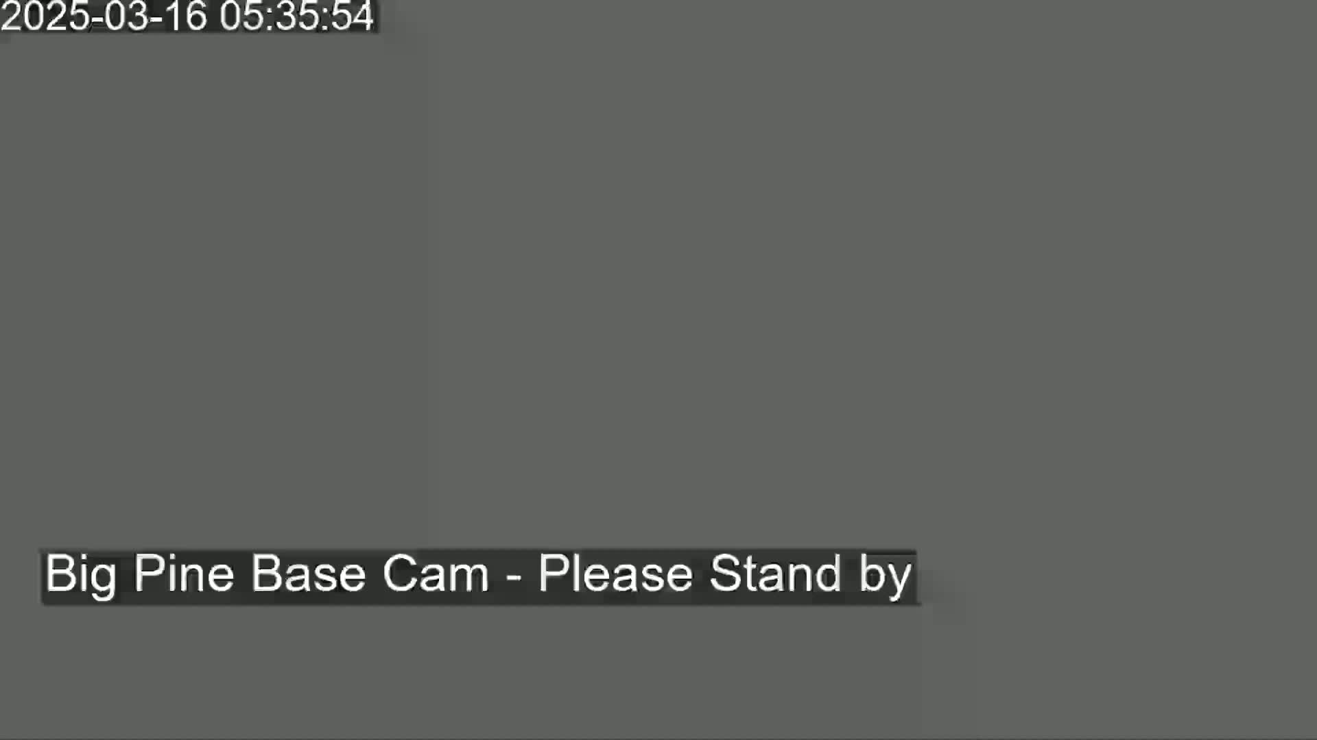 The image shows a solid dark gray screen with the message "Big Pine Base Cam - Please Stand by".