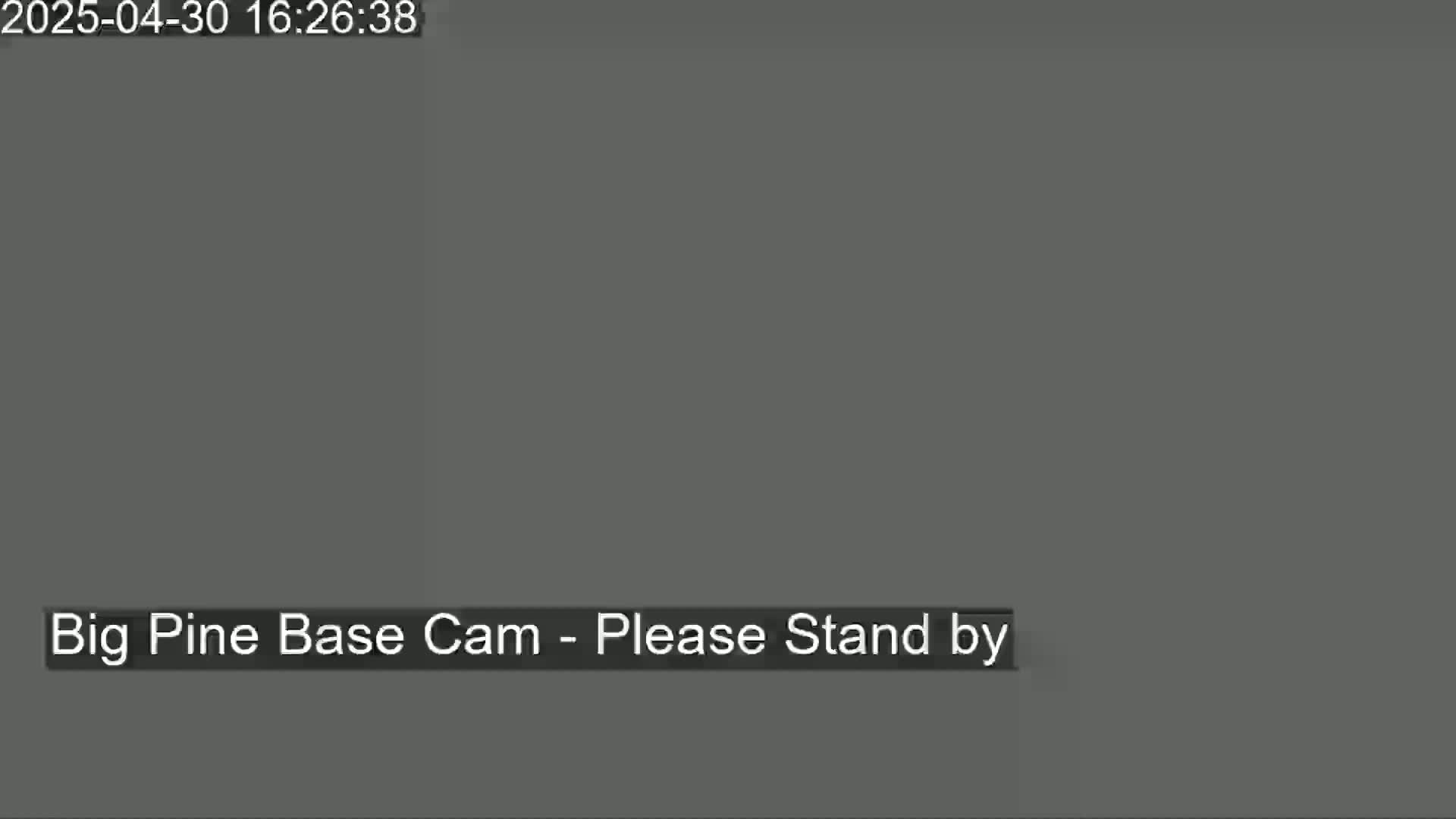 The image shows a dark gray screen with the message "Big Pine Base Cam - Please Stand by."