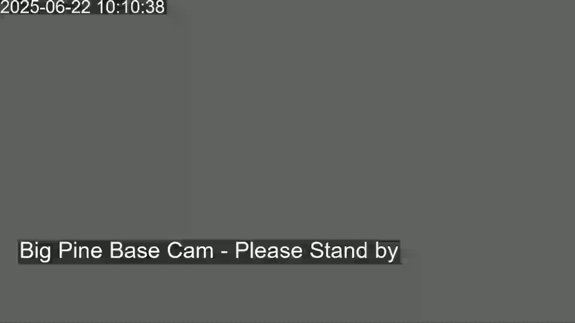 The image shows a solid dark gray screen with the message "Big Pine Base Cam - Please Stand by".