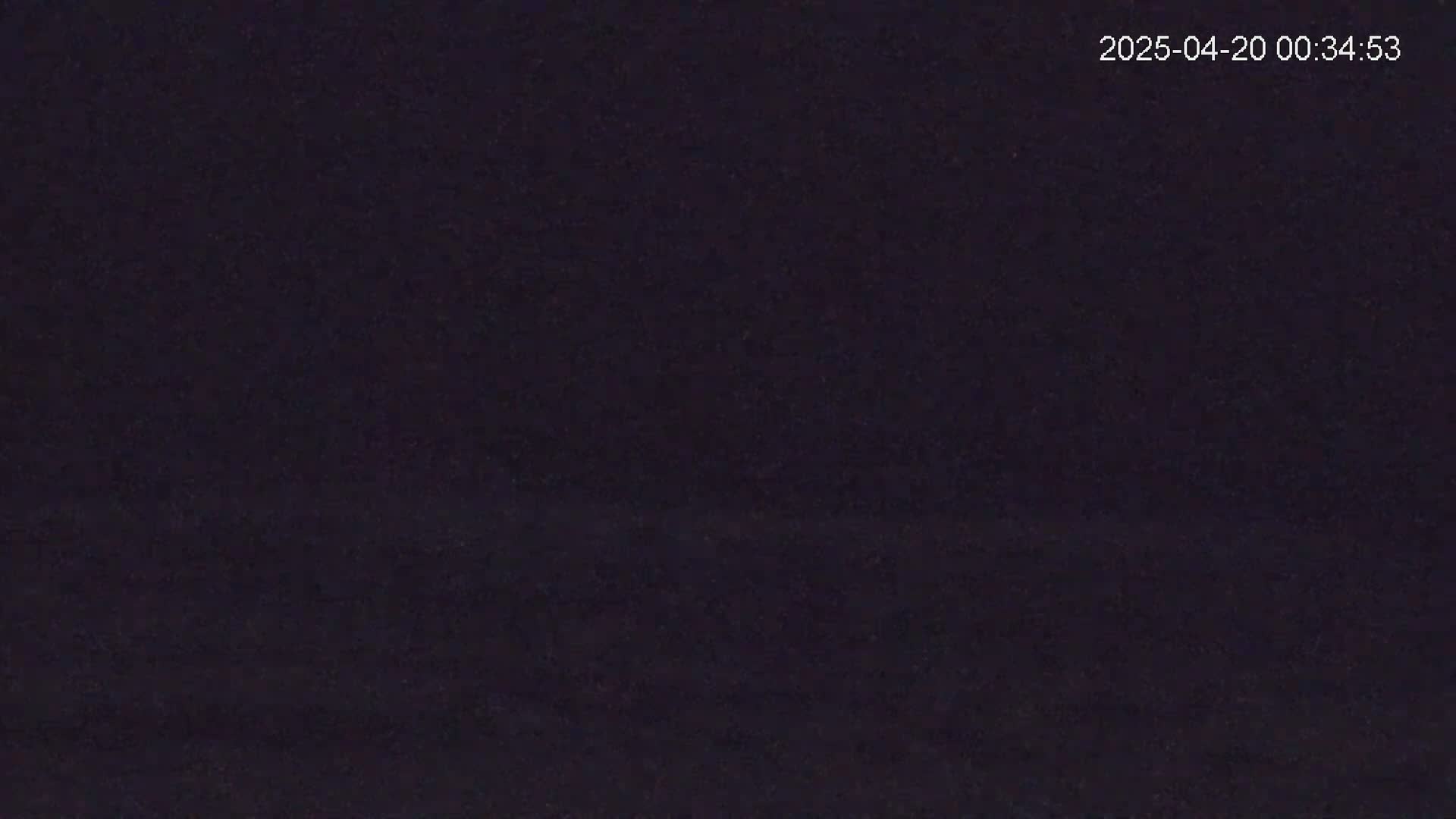 A dark, possibly nighttime, scene shows a uniformly dark surface.