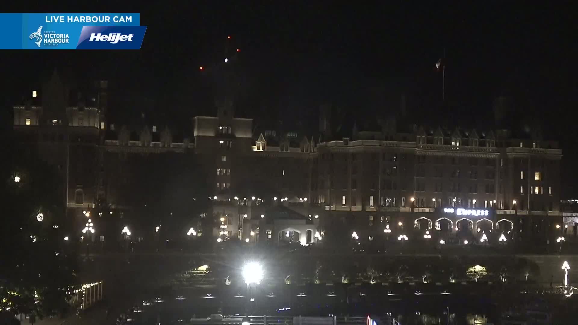 A large, dark building, possibly a hotel, is illuminated at night.