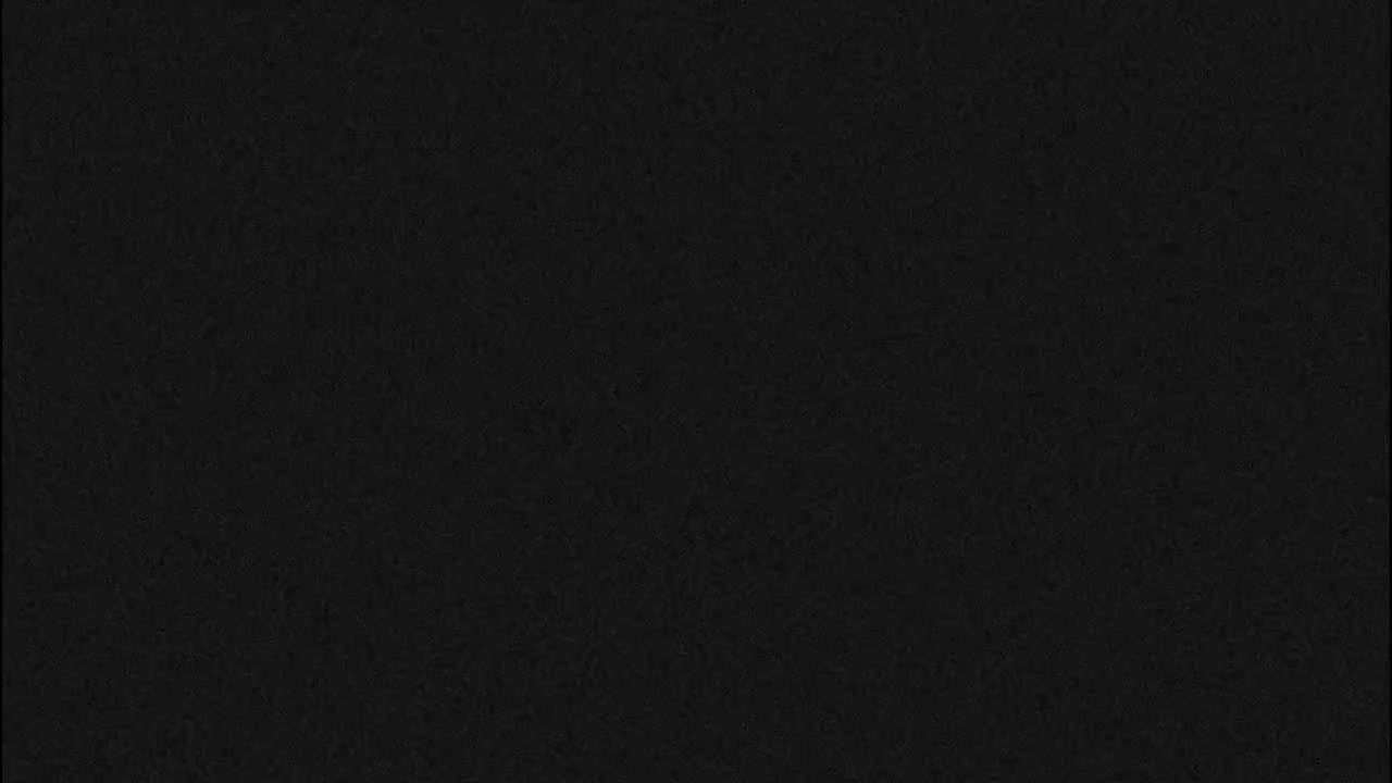 The image displays a dark, almost entirely black background with a subtle, mottled texture.