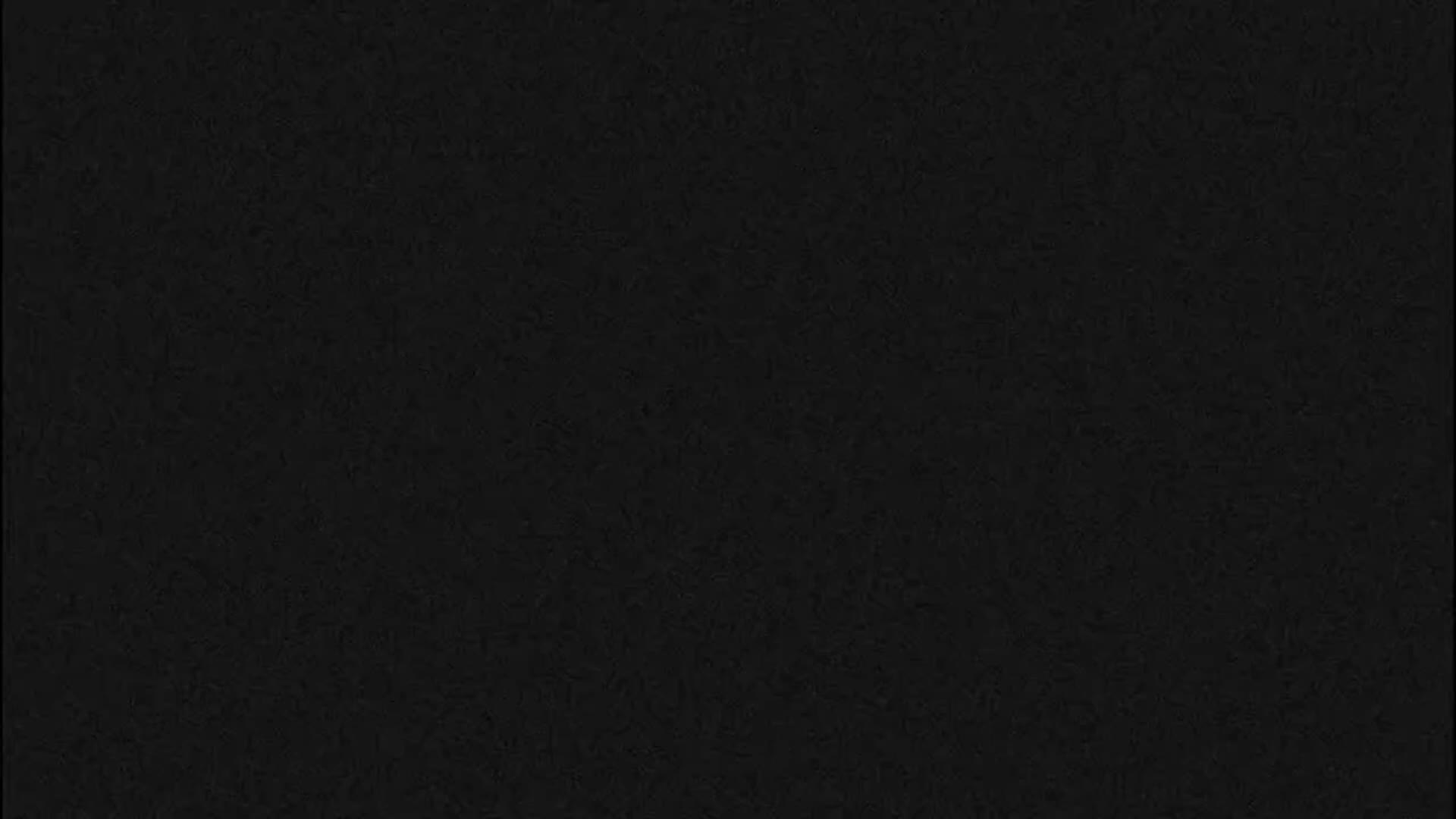 The image is entirely black with a subtle, fine grainy texture.