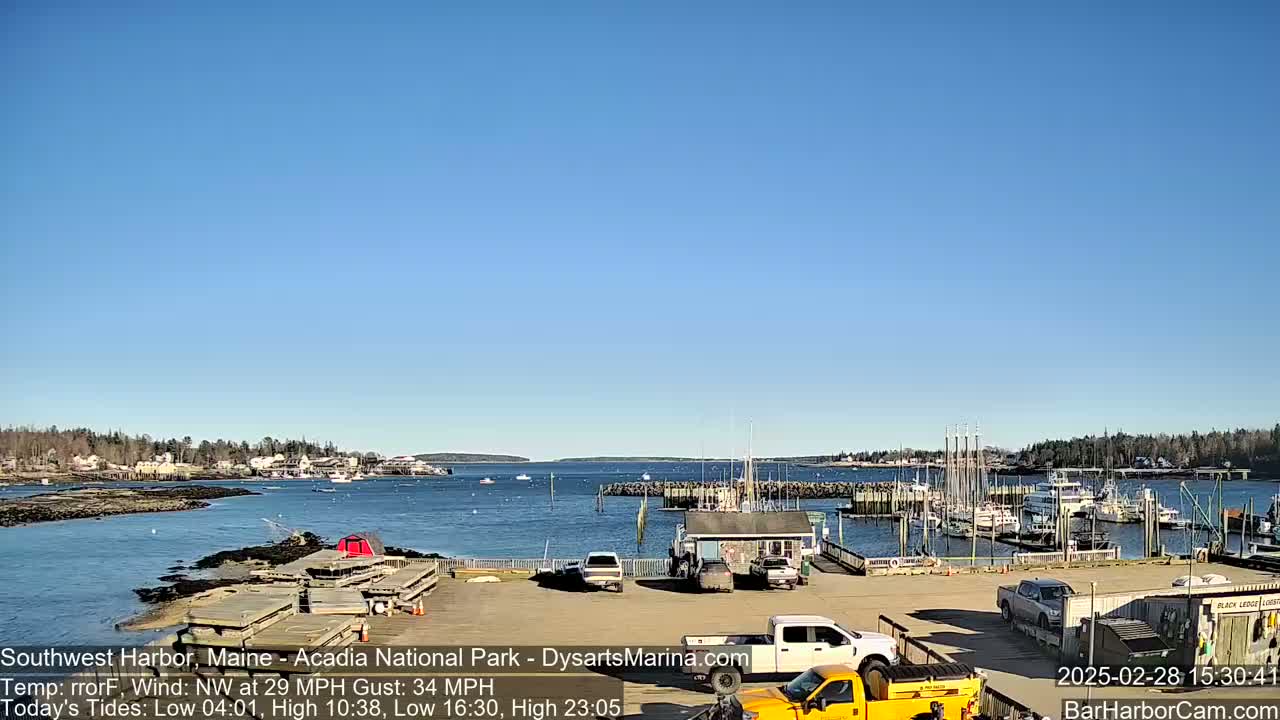 A harbor filled with boats under a clear blue sky, with a light northwest wind.