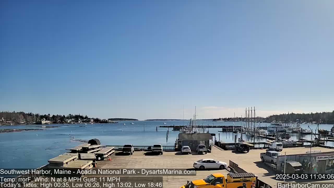 A harbor filled with docked boats on a sunny day under a clear blue sky.