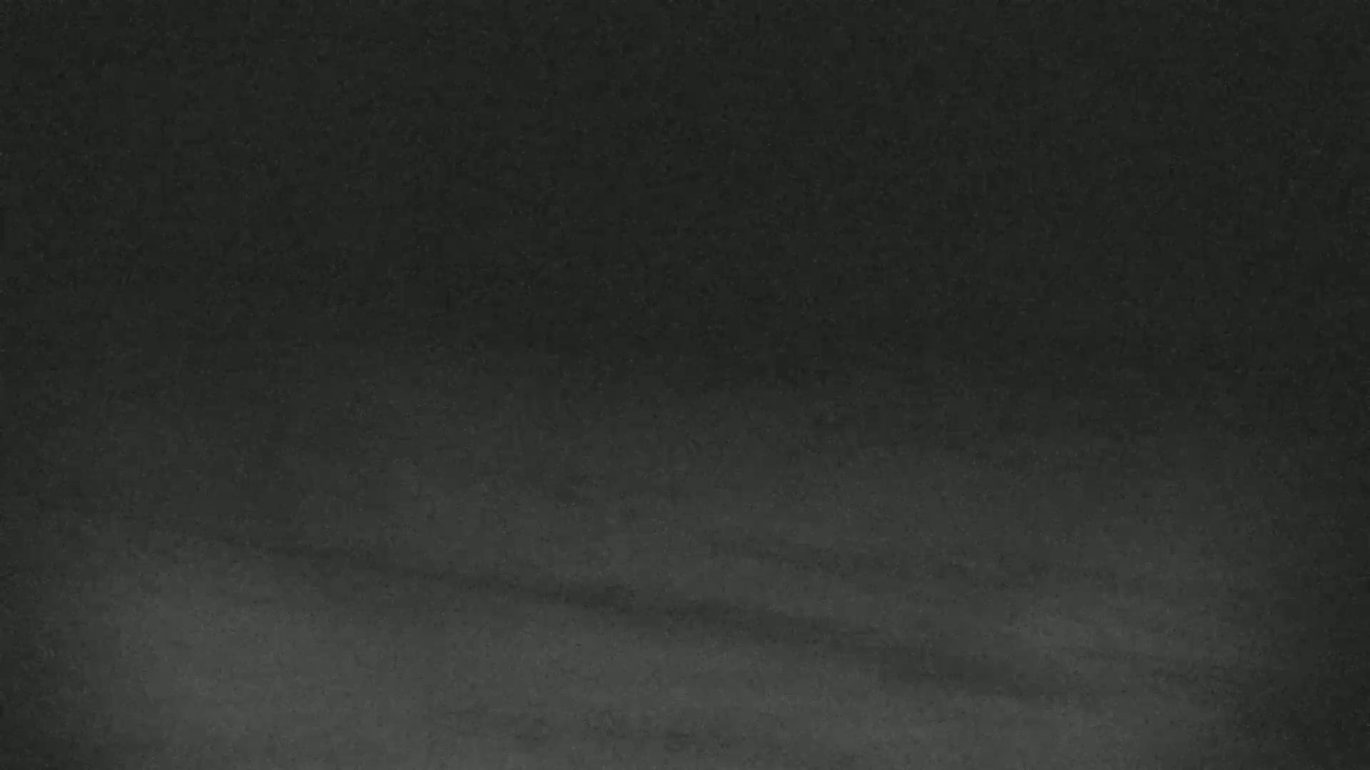A dark gray, textured surface appears to be slightly sloped.