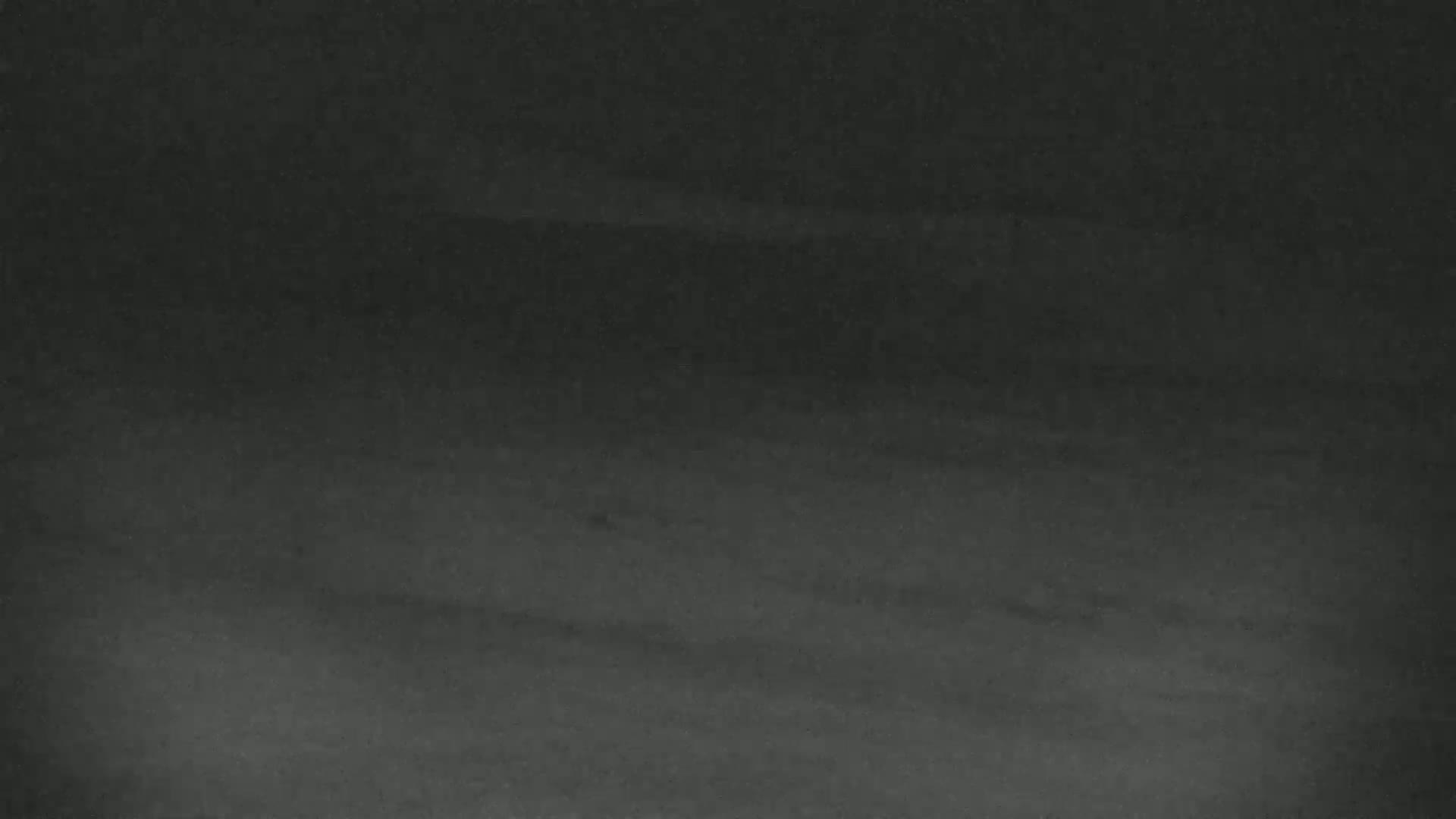 The image shows a dark gray or black surface with subtle variations in shading.