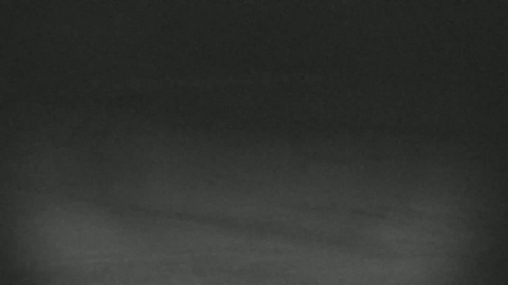A dark gray, textured surface, possibly a chalkboard or similar material, is shown.