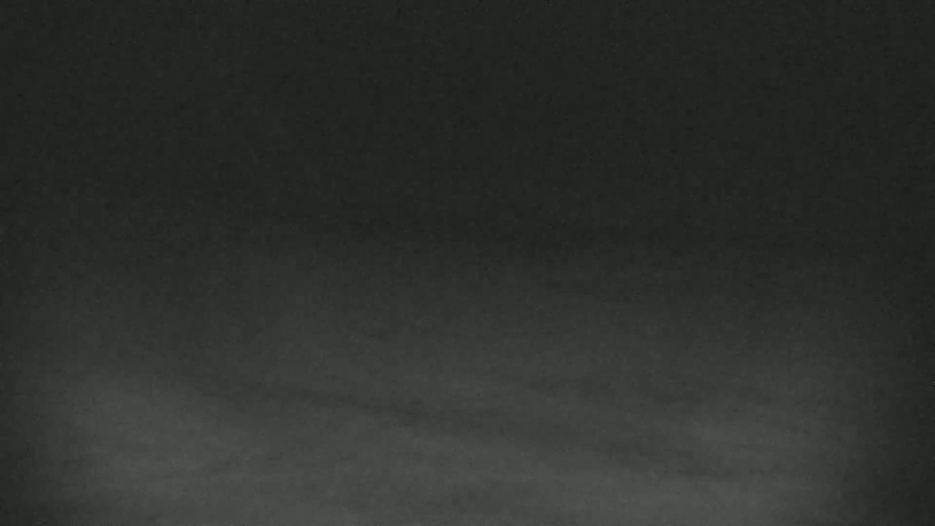 The image shows a dark gray or black textured surface, possibly a chalkboard or similar material.