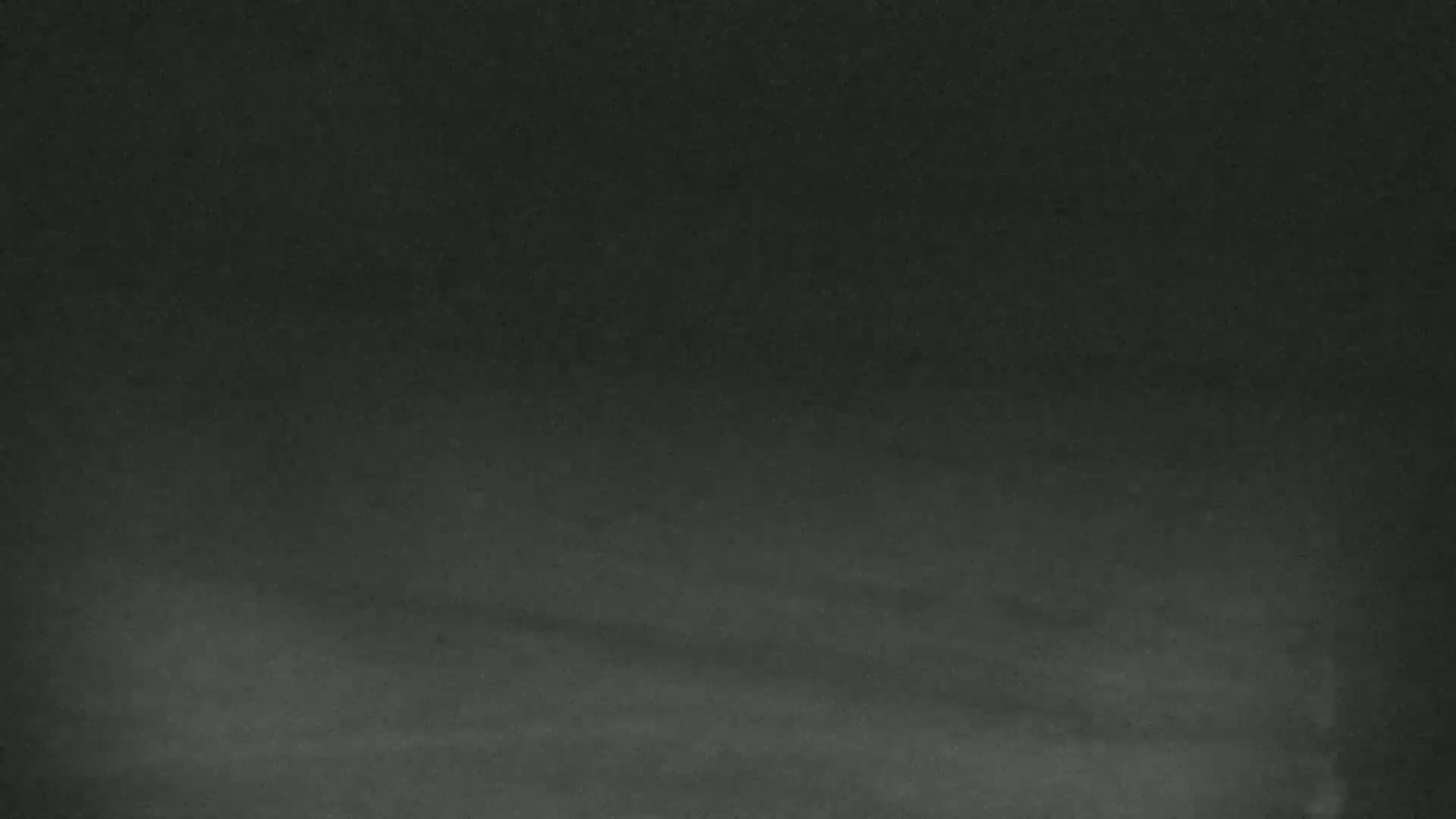 The image shows a dark gray surface with subtle horizontal streaks.