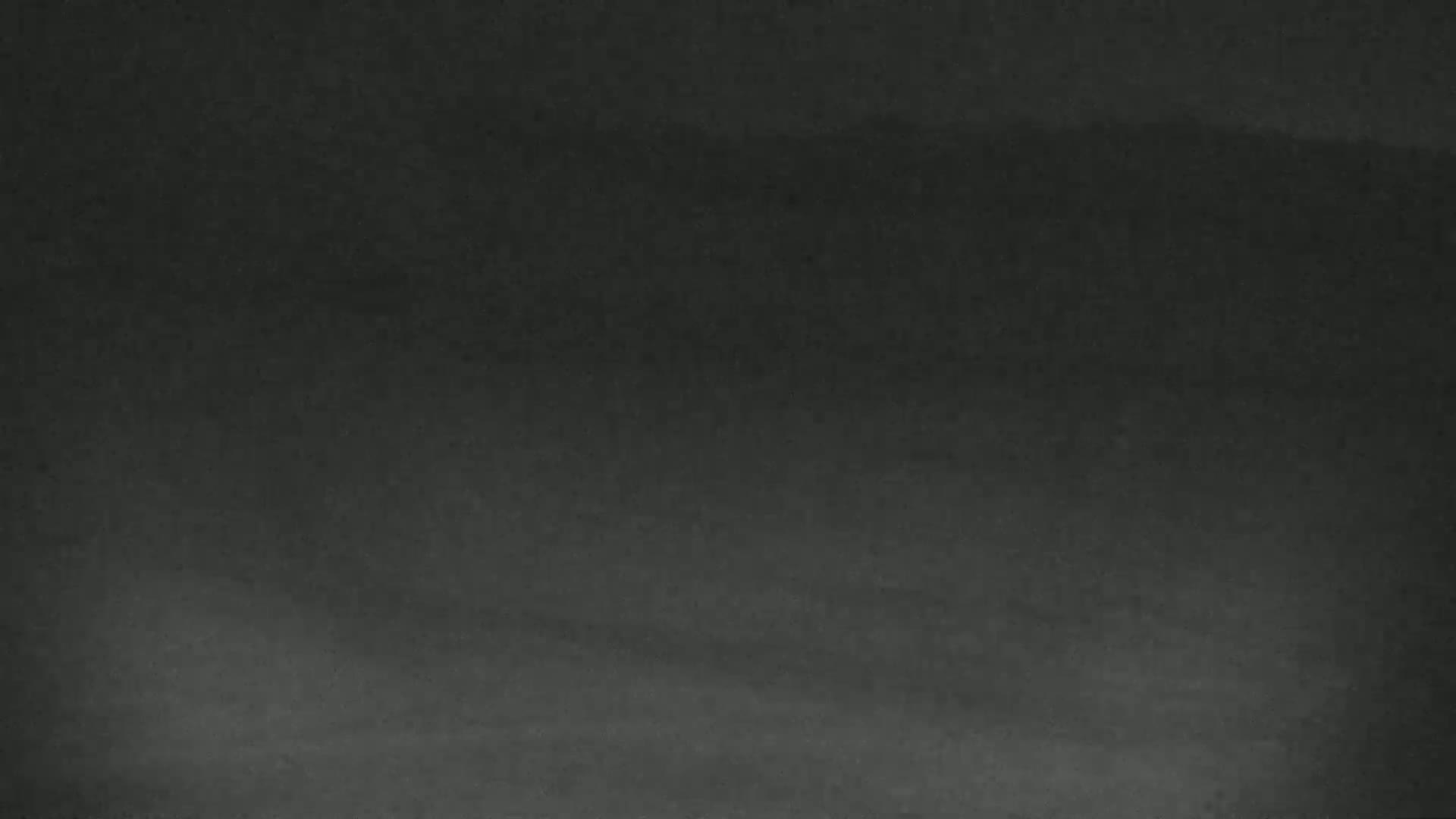 The image shows a dark gray or black textured surface.