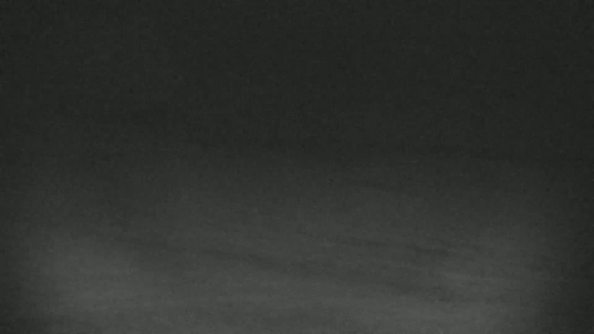 The image shows a dark gray textured surface.