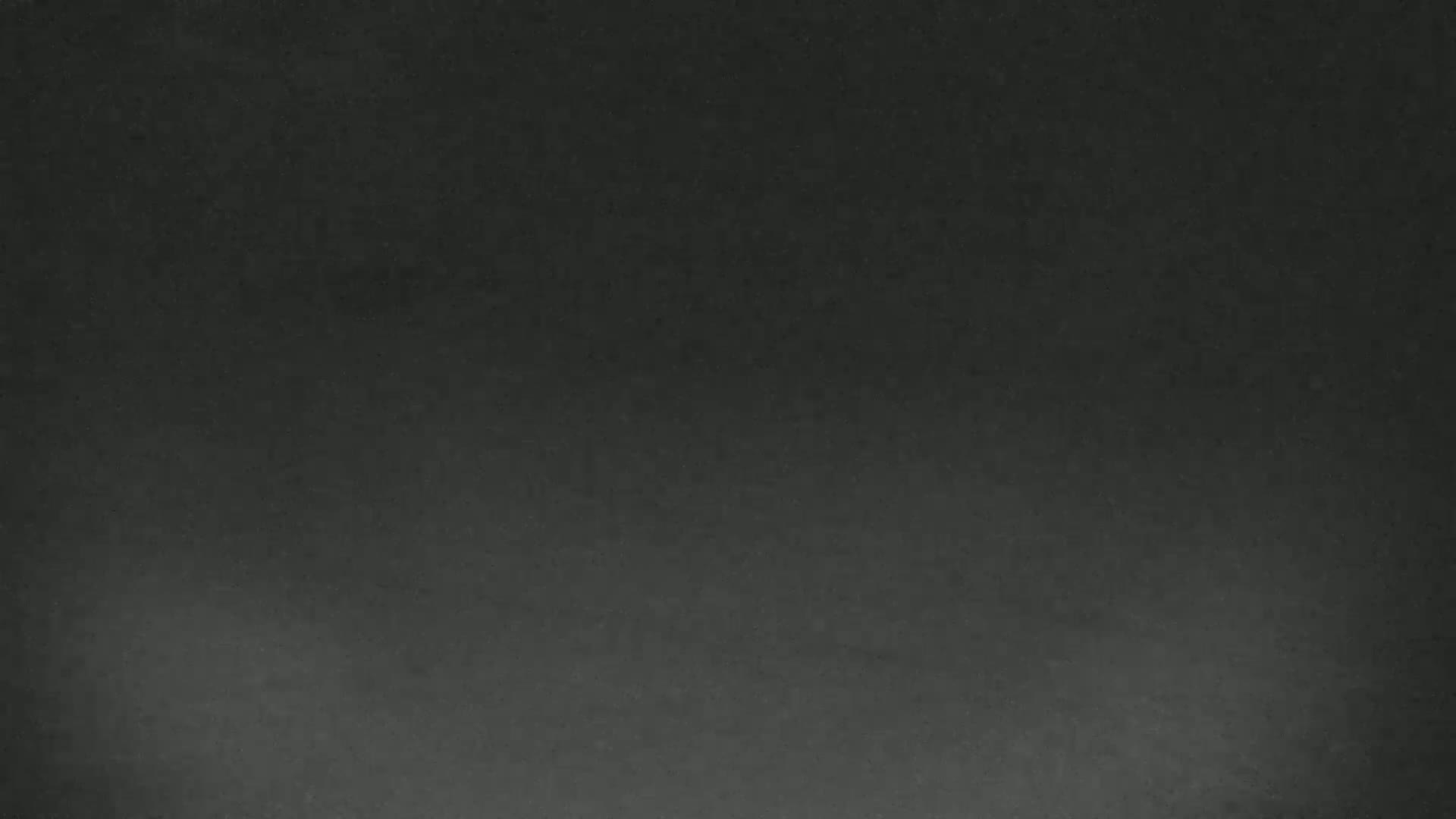 A dark, possibly nighttime, image shows a mostly featureless sky with a few faint, hazy light sources.