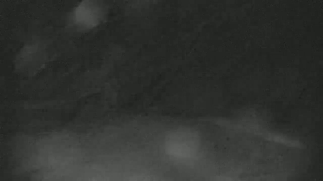 A blurry, dark gray image shows indistinct shapes and hazy patches of light.