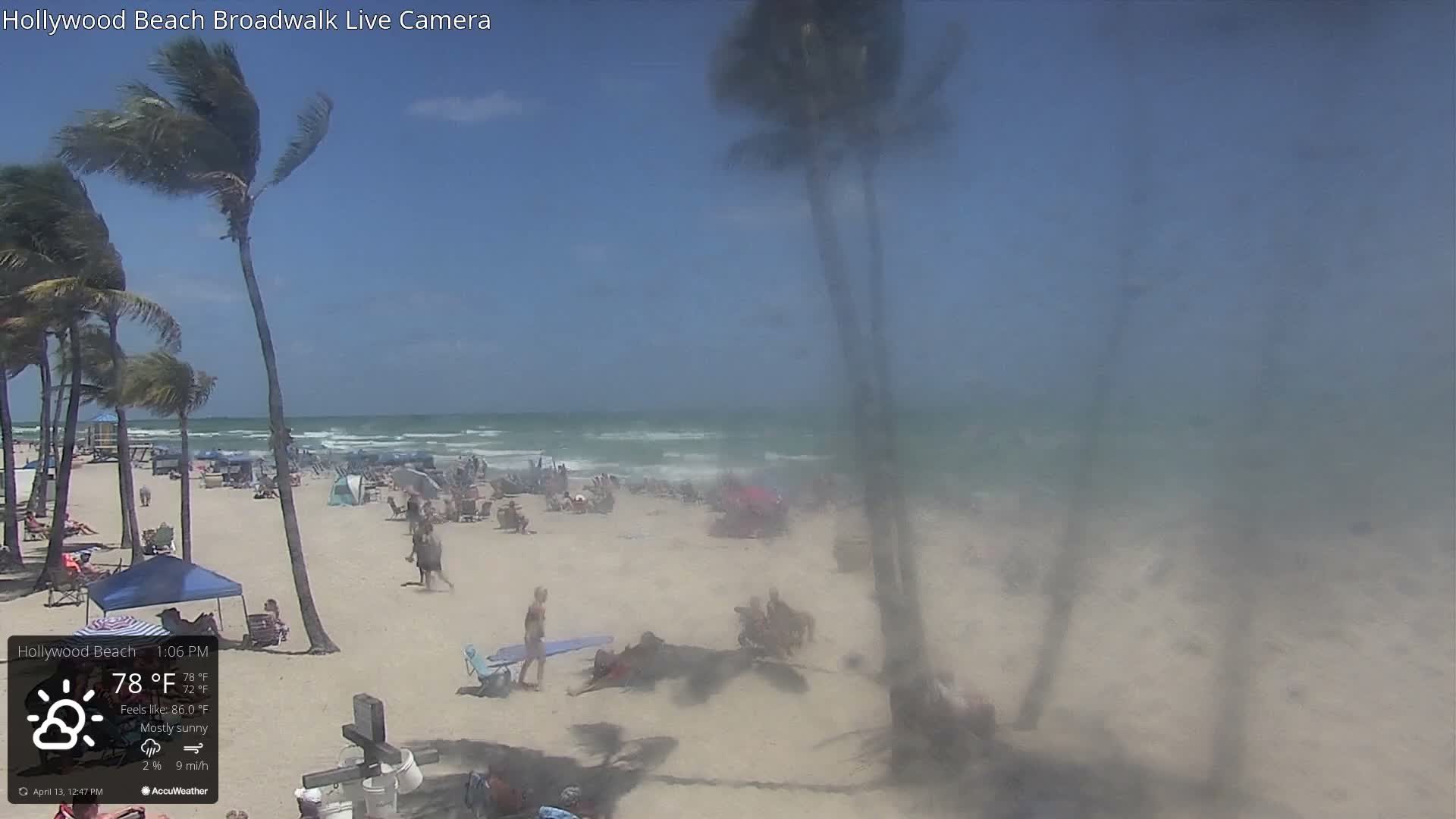 An outdoor surf simulator is visible below an illuminated elevated bar area at night, under mostly cloudy skies with a temperature of 72°F.