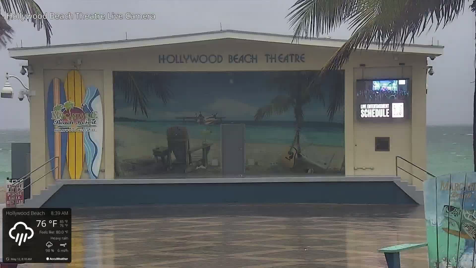 A beachfront theater is partially submerged in floodwaters during heavy rain.