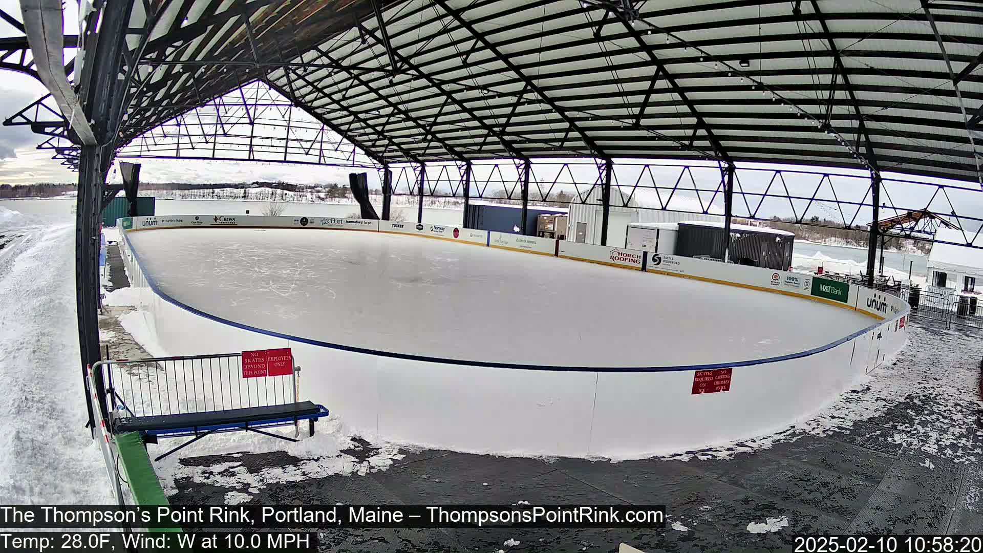 A partially covered outdoor ice rink, with snow on the ground and a west wind, is visible.