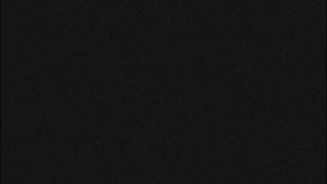 The image is a solid dark-grey or black textured surface.