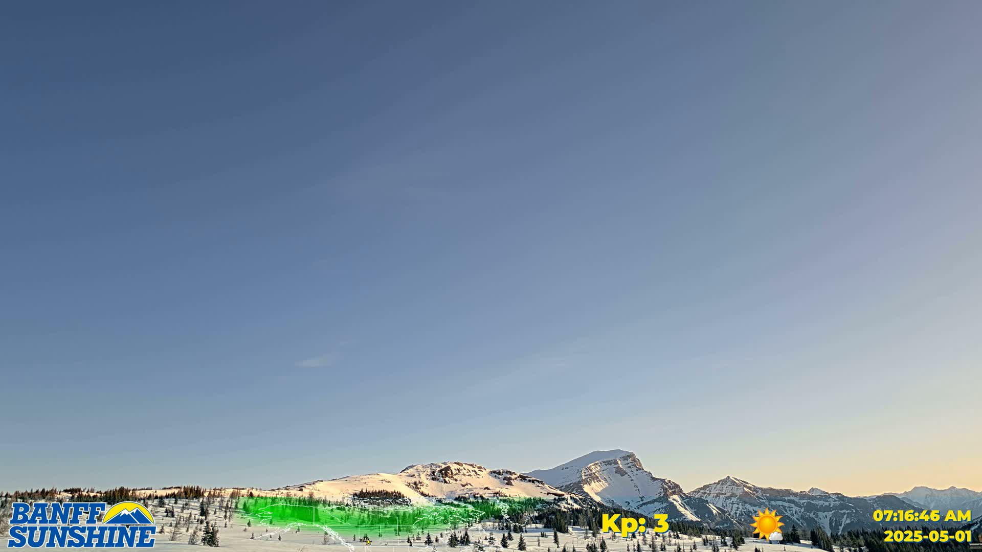 Under a clear blue sky, snow-capped mountains are partially visible behind a mostly snow-covered foreground.