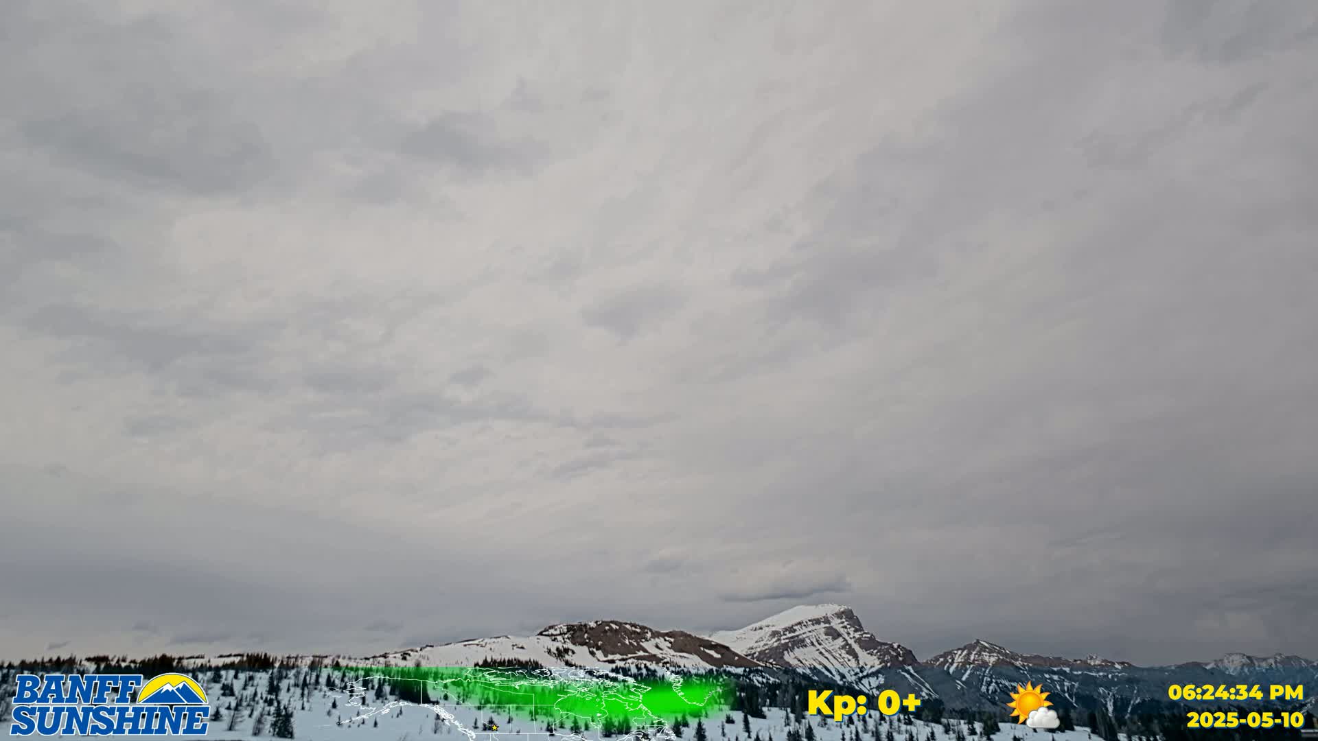 Snow-covered mountains are visible under an overcast sky.