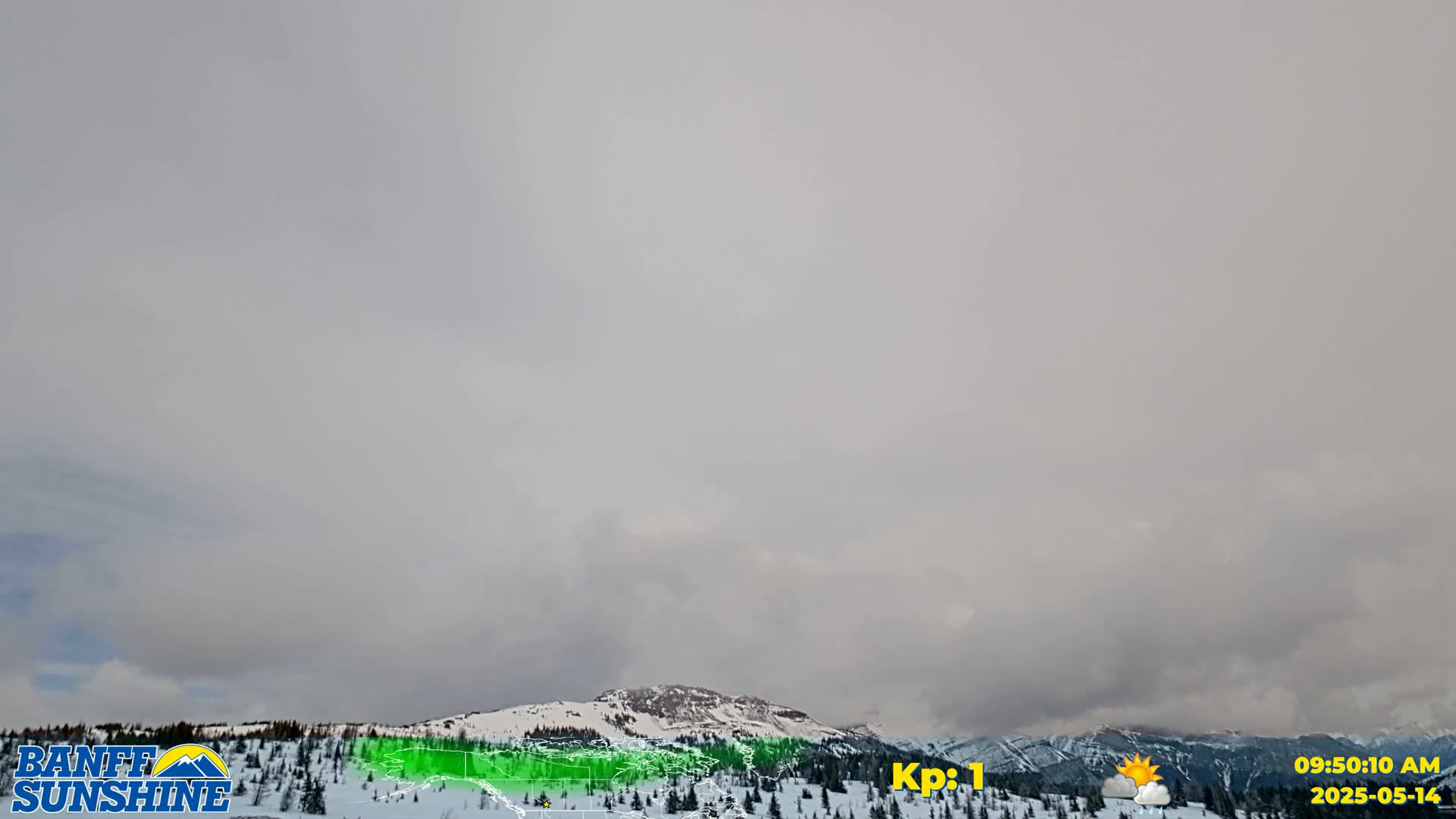 A snow-covered mountain range is visible under an overcast sky.