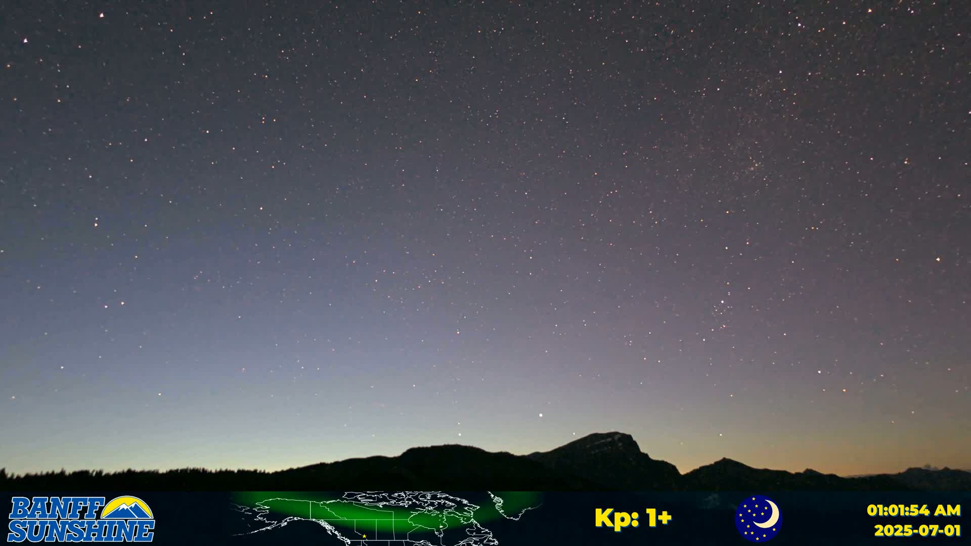A night sky filled with stars is visible above a dark mountain range under clear conditions.