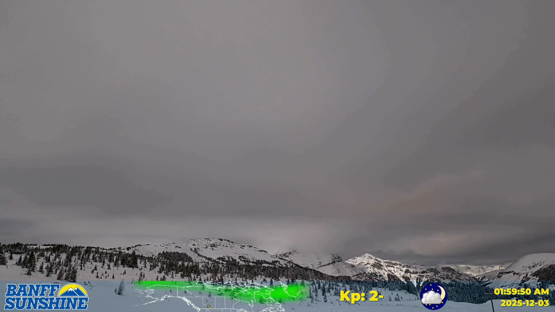 A panoramic view reveals a snow-covered mountain range with scattered evergreen trees beneath a dark, uniformly overcast sky.