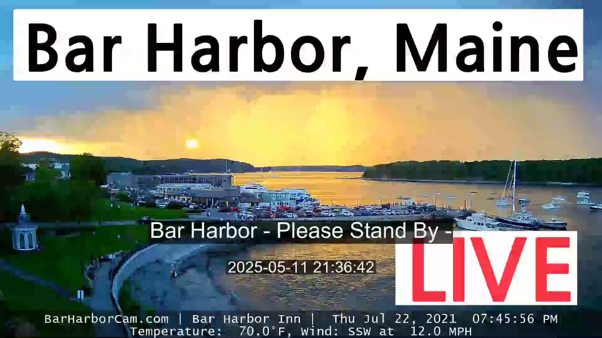 A harbor filled with boats at sunset under a partly cloudy sky.