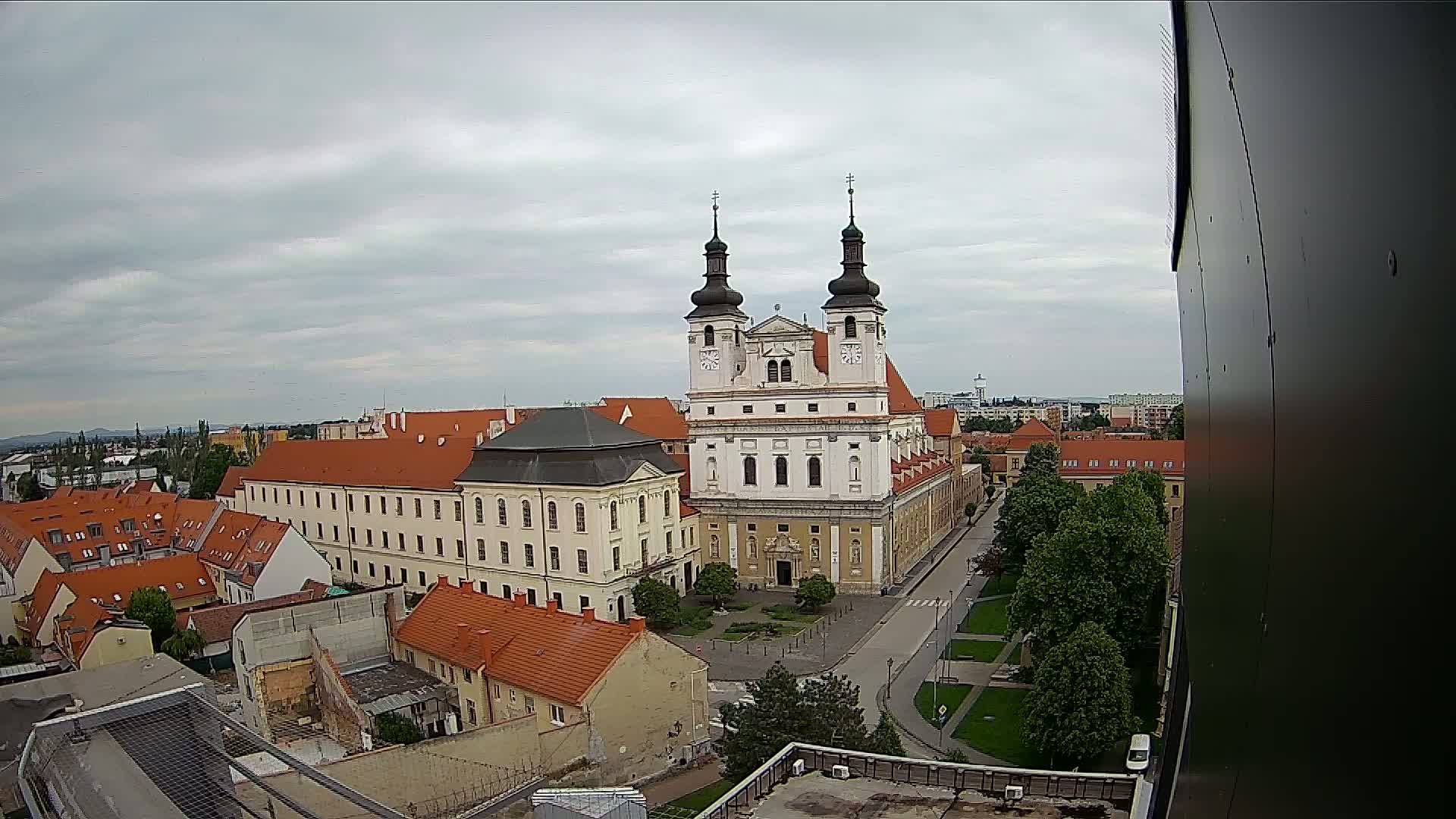 An elevated view of a large church and surrounding buildings on an overcast day.