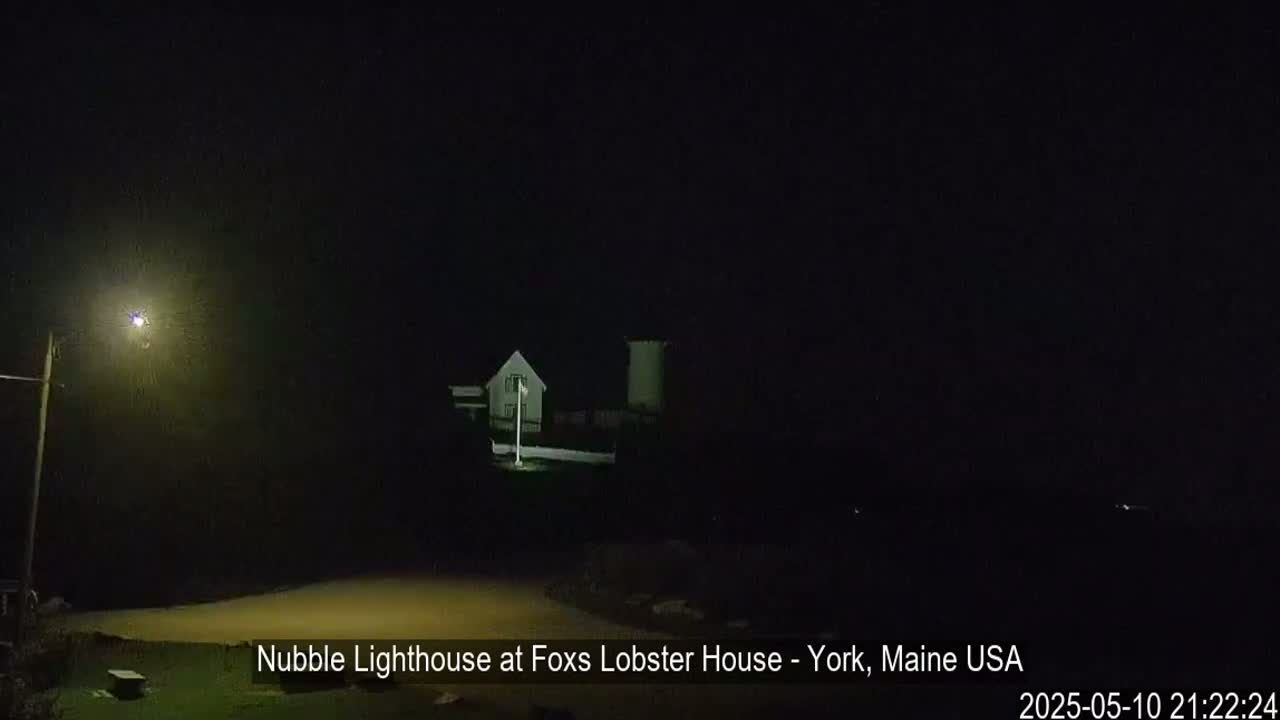 A lighthouse is dimly lit at night.