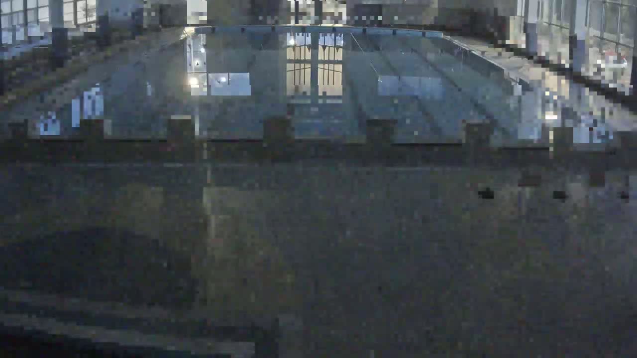 An indoor swimming pool is seen from above at night.