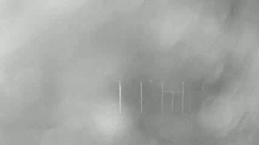 A gray, textured surface with faint, vertical, scratch-like marks.