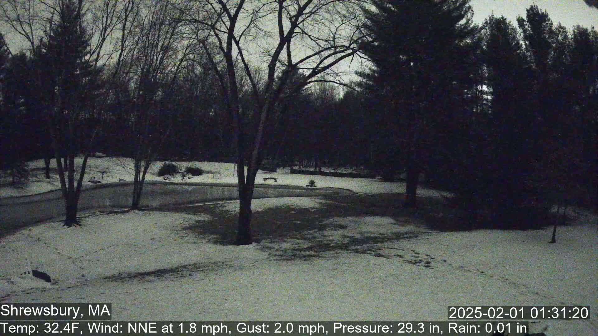 A snow-covered, tree-lined area is visible under an overcast sky.