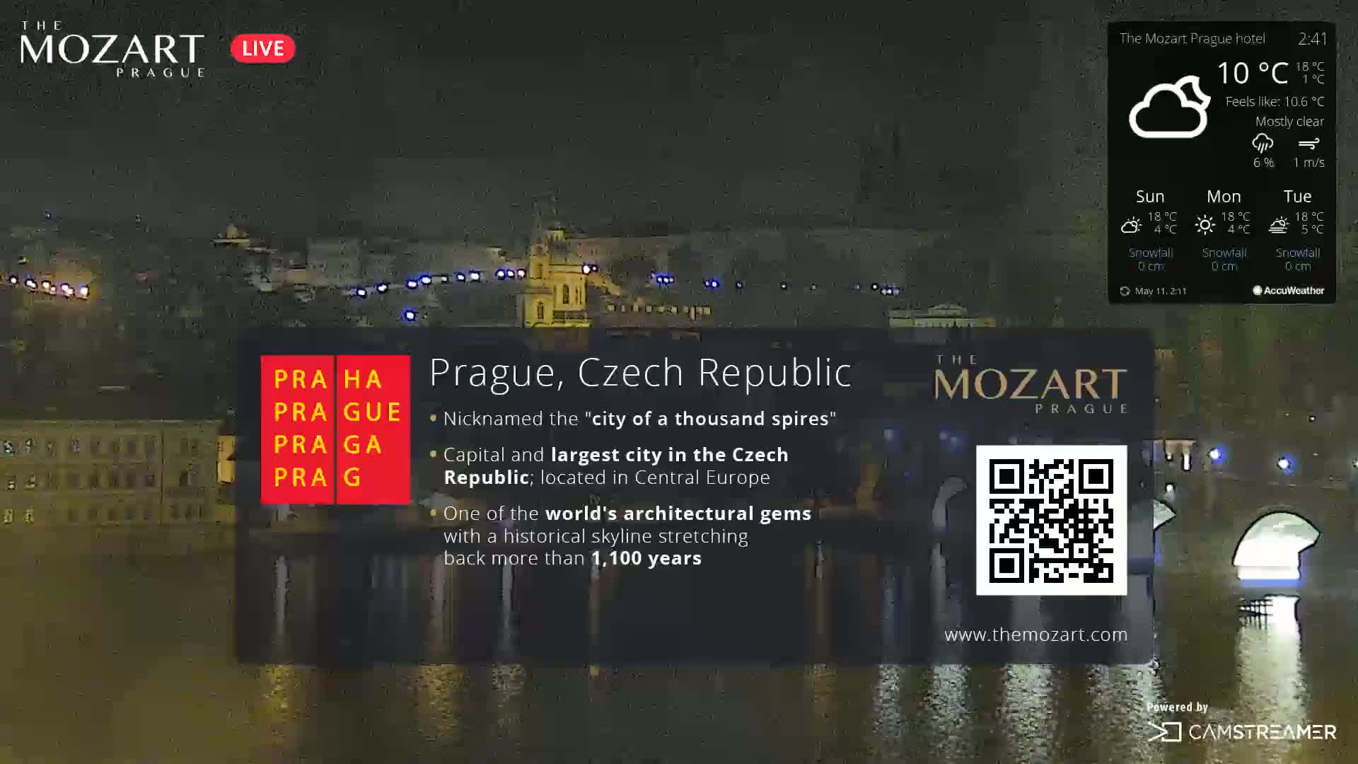 A nighttime view of Prague, Czech Republic, under mostly clear skies and a temperature of 10°C.