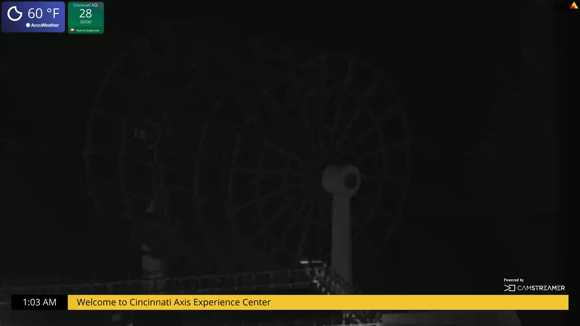 A nighttime, low-light view of a Ferris wheel.